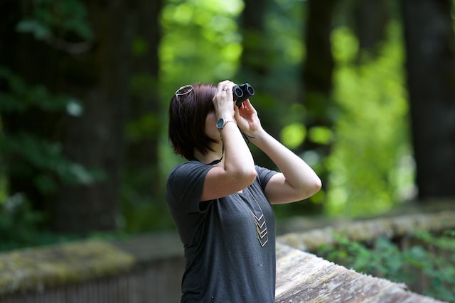 bird watching vacation - woman with binoculars 