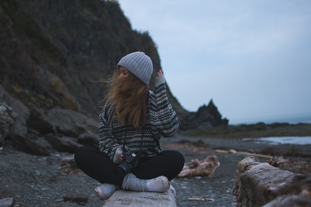 girl outside in sweater in fall on fall road trip 